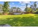 Spacious backyard featuring a well-maintained lawn, wooden fence and a covered deck at 425 Houze Way, Roswell, GA 30076