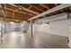 Spacious unfinished basement featuring wood flooring and access to stairs with painted white walls at 425 Houze Way, Roswell, GA 30076