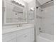 Bathroom featuring white cabinets, marble countertop, and tiled walls at 425 Houze Way, Roswell, GA 30076