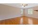 Spacious bedroom with hardwood floors, ceiling fan and natural light from windows at 425 Houze Way, Roswell, GA 30076