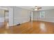 This bedroom has hardwood floors, neutral paint, a ceiling fan, and ample closet space at 425 Houze Way, Roswell, GA 30076