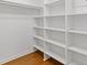 Walk-in closet features built in shelving and hardwood floors at 425 Houze Way, Roswell, GA 30076