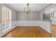 Open-concept dining area with hardwood floors, ample natural light, and modern lighting fixtures, perfect for Gathering gatherings at 425 Houze Way, Roswell, GA 30076