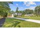 Long driveway leading up to a well-kept two-story home with mature trees and expansive lawn at 425 Houze Way, Roswell, GA 30076