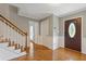 Bright foyer with hardwood flooring, staircase, and a stained glass front door at 425 Houze Way, Roswell, GA 30076