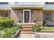 Inviting brick entryway with a decorative front door and manicured landscaping at 425 Houze Way, Roswell, GA 30076
