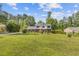 Charming two-story home with a brick and white facade, lush lawn and beautiful landscaping at 425 Houze Way, Roswell, GA 30076