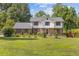 Attractive two-story home with a brick and white exterior, complemented by a large, green front lawn at 425 Houze Way, Roswell, GA 30076