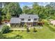 Charming two-story home with a well-manicured front lawn and a classic brick facade with decorative shutters at 425 Houze Way, Roswell, GA 30076
