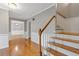 Hallway with hardwood floors, a staircase, and neutral paint creates a welcoming and bright entrance at 425 Houze Way, Roswell, GA 30076