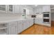 Beautiful, bright kitchen featuring stainless steel appliances, white cabinets, and hardwood floors, offering a modern design at 425 Houze Way, Roswell, GA 30076