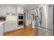 Updated kitchen with stainless steel appliances, white cabinets, and hardwood floors, seamlessly blending style and functionality at 425 Houze Way, Roswell, GA 30076