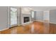 Living area with hardwood floors, decorative fireplace, and open doorway, creating a warm and inviting atmosphere at 425 Houze Way, Roswell, GA 30076