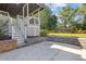 Outdoor patio featuring stone accents, a staircase leading to a deck, and ample space for outdoor seating at 425 Houze Way, Roswell, GA 30076