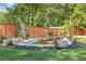 Backyard pond with stone accents surrounded by mulch and a wooden fence, a charming outdoor feature at 425 Houze Way, Roswell, GA 30076