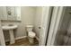 Half bath with pedestal sink and tile flooring at 4550 Cypress Ridge Ct, Stone Mountain, GA 30083