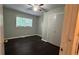 Bedroom with hardwood floors, window, and closet at 4550 Cypress Ridge Ct, Stone Mountain, GA 30083