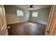 A bedroom features hardwood floors, natural paint, and two bright windows at 4550 Cypress Ridge Ct, Stone Mountain, GA 30083