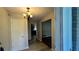 Inviting hallway with updated light fixtures and a glimpse of a modern kitchen at 4550 Cypress Ridge Ct, Stone Mountain, GA 30083