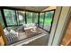 Bright sunroom with comfortable furniture and windows overlooking the backyard at 4550 Cypress Ridge Ct, Stone Mountain, GA 30083