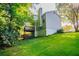 View of a charming backyard featuring a two-story deck and lush green grass at 7021 New Dale Rd, Rex, GA 30273