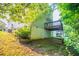Charming backyard with a wooden deck, flower bed, and mature trees at 7021 New Dale Rd, Rex, GA 30273