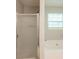 Bathroom featuring shower with glass door, tub and a window at 7021 New Dale Rd, Rex, GA 30273