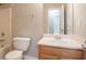 This bathroom has a white toilet and sink with a light wood cabinet at 7021 New Dale Rd, Rex, GA 30273