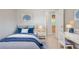 Comfortable bedroom with blue accents, a cozy bed, and study space at 7021 New Dale Rd, Rex, GA 30273