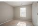 This bedroom features neutral walls, carpet, and a window for natural light at 7021 New Dale Rd, Rex, GA 30273
