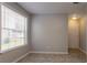Neutral bedroom with a window letting in light and door for easy access at 7021 New Dale Rd, Rex, GA 30273