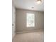 Bright and airy bedroom with neutral walls, carpet, and plenty of natural light at 7021 New Dale Rd, Rex, GA 30273