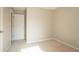 This bedroom features neutral walls, carpet, and a white door at 7021 New Dale Rd, Rex, GA 30273