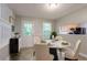 Cozy dining area featuring a modern table set, bright light, and kitchen view at 7021 New Dale Rd, Rex, GA 30273