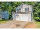 Exterior view of a two-story home showcasing a two-car garage and well-maintained siding at 7021 New Dale Rd, Rex, GA 30273