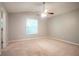 Spacious main bedroom featuring plush carpet, a ceiling fan, and a window at 7021 New Dale Rd, Rex, GA 30273