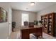 Home office featuring a large wooden desk, bookcase, and natural light at 7021 New Dale Rd, Rex, GA 30273