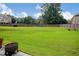 Expansive backyard with lush green grass offers ample space for outdoor activities and relaxation at 3015 Guardian Nw Walk, Kennesaw, GA 30152