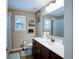 Well-lit bathroom with a large mirror and vanity with white countertop and dark cabinets at 3015 Guardian Nw Walk, Kennesaw, GA 30152