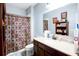 Bathroom with modern vanity, neutral tile flooring and shower curtain with patterned design at 3015 Guardian Nw Walk, Kennesaw, GA 30152