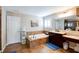 Elegant bathroom with a soaking tub, dark wood vanity, and neutral color scheme at 3015 Guardian Nw Walk, Kennesaw, GA 30152