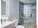 Modern bathroom with an illuminated mirror and a glass-enclosed shower with built in shelving at 3015 Guardian Nw Walk, Kennesaw, GA 30152