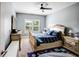 Comfortable bedroom with a ceiling fan, carpeted floors, and a large window letting in natural light at 3015 Guardian Nw Walk, Kennesaw, GA 30152