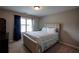 Comfortable bedroom with a tufted headboard, soft bedding, and natural light from the window at 3015 Guardian Nw Walk, Kennesaw, GA 30152
