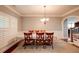 Formal dining room with wainscoting, plantation shutters, and stylish chandelier at 3015 Guardian Nw Walk, Kennesaw, GA 30152