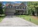 Charming two-story brick home featuring an attached two-car garage and mature landscaping at 3015 Guardian Nw Walk, Kennesaw, GA 30152
