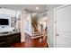 Hallway view with hardwood flooring, and access to the living room, stairs and a white door at 3015 Guardian Nw Walk, Kennesaw, GA 30152