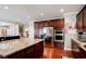 Gourmet kitchen featuring stainless steel appliances and beautiful granite countertops with wooden cabinets at 3015 Guardian Nw Walk, Kennesaw, GA 30152