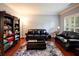 Cozy living room features hardwood floors, large windows, and elegant furnishings, creating a comfortable atmosphere at 3015 Guardian Nw Walk, Kennesaw, GA 30152
