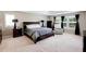 Spacious main bedroom with a large bed, soft carpet, and a view of outside at 3015 Guardian Nw Walk, Kennesaw, GA 30152